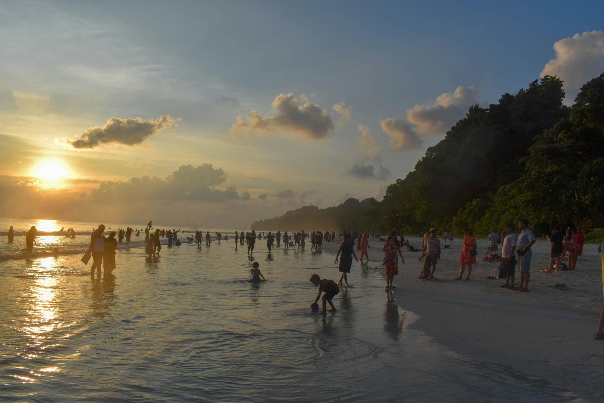 Sunset at an Andaman beach with travellers in the shallows